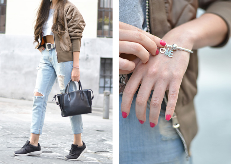 Street style outfit, bomber jacket, ripped jeans, running sneakers, crop top, pandora bracelet, casual look