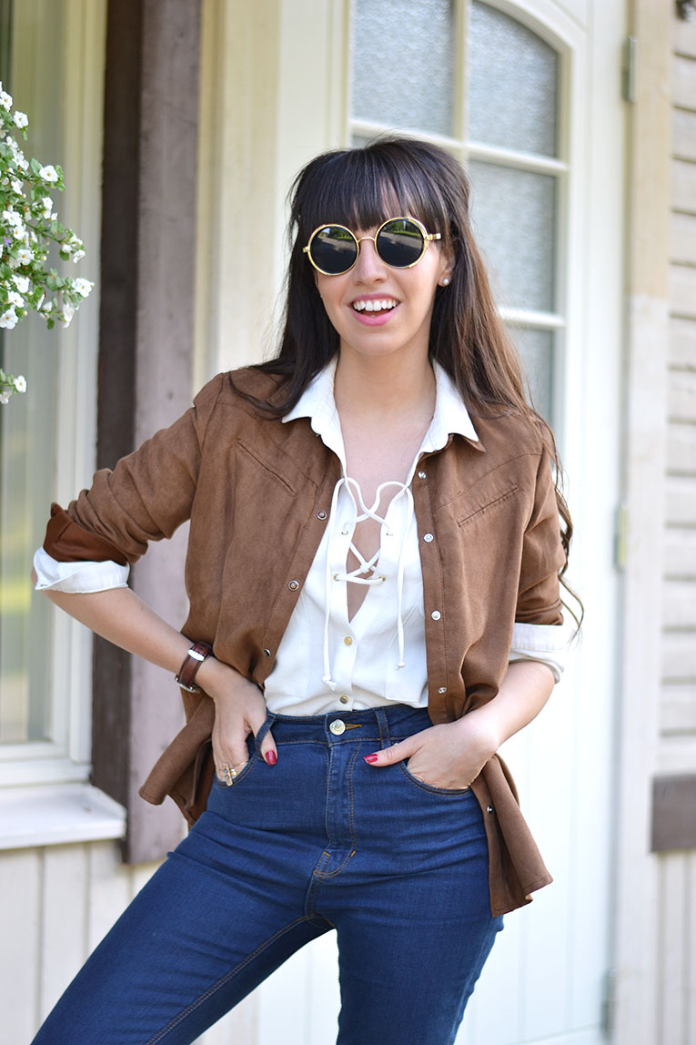 Street style, suede shirt, lace up blouse, high waisted jeans, round sunglasses, white sneakers