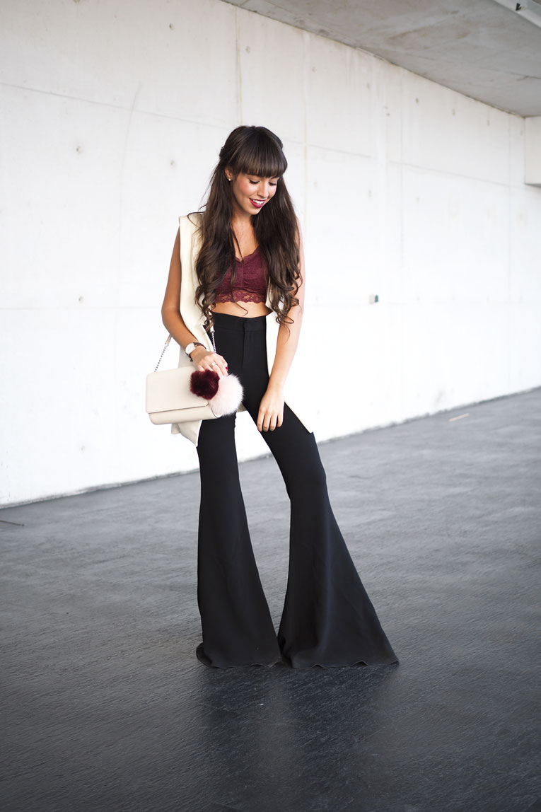 Street style, extra flared pants, lace top, long vest, pom pom bag, MBFW